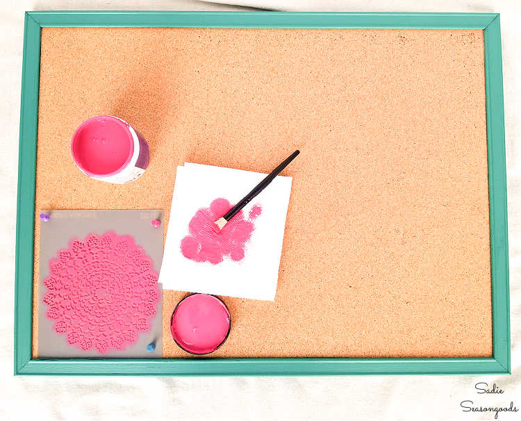 using a stencil to decorate an office corkboard