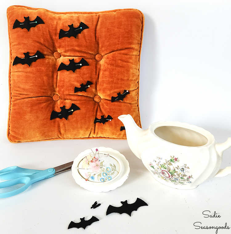 pinning felt bats to a velvet pillow