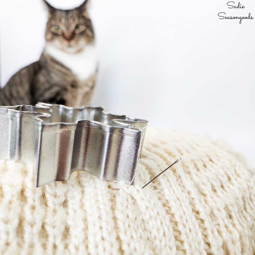 attaching metal cookie cutters to a winter door wreath