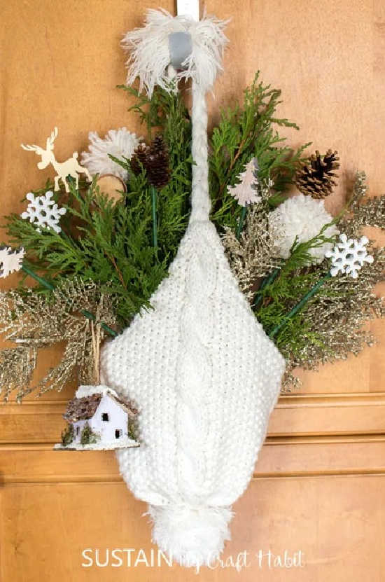 upcycling a winter hat as door decor